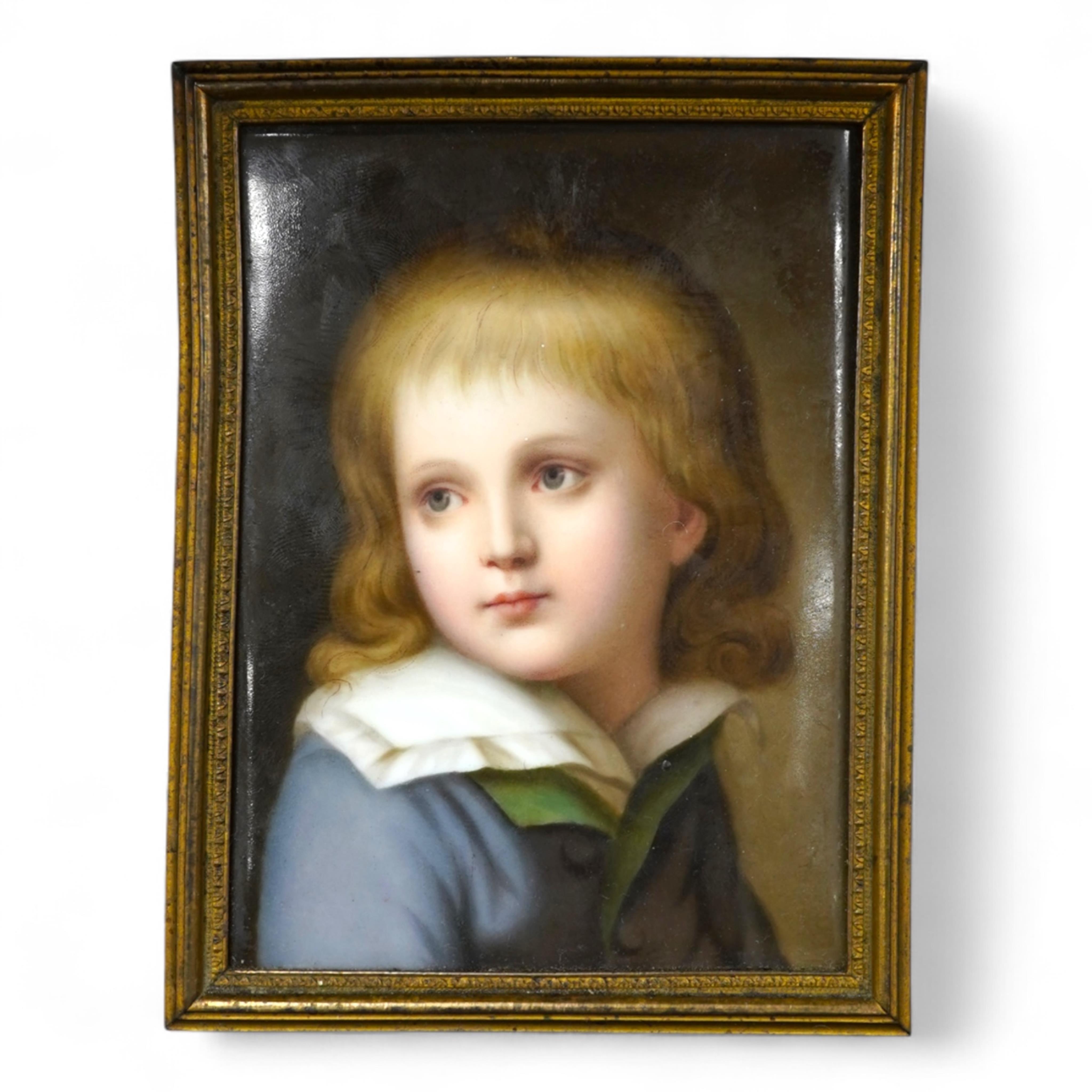A late 19th century German porcelain plaque, painted with the portrait of a boy, possibly Dauphin Louis XVII, in gilt metal frame, 11cm x 8cm